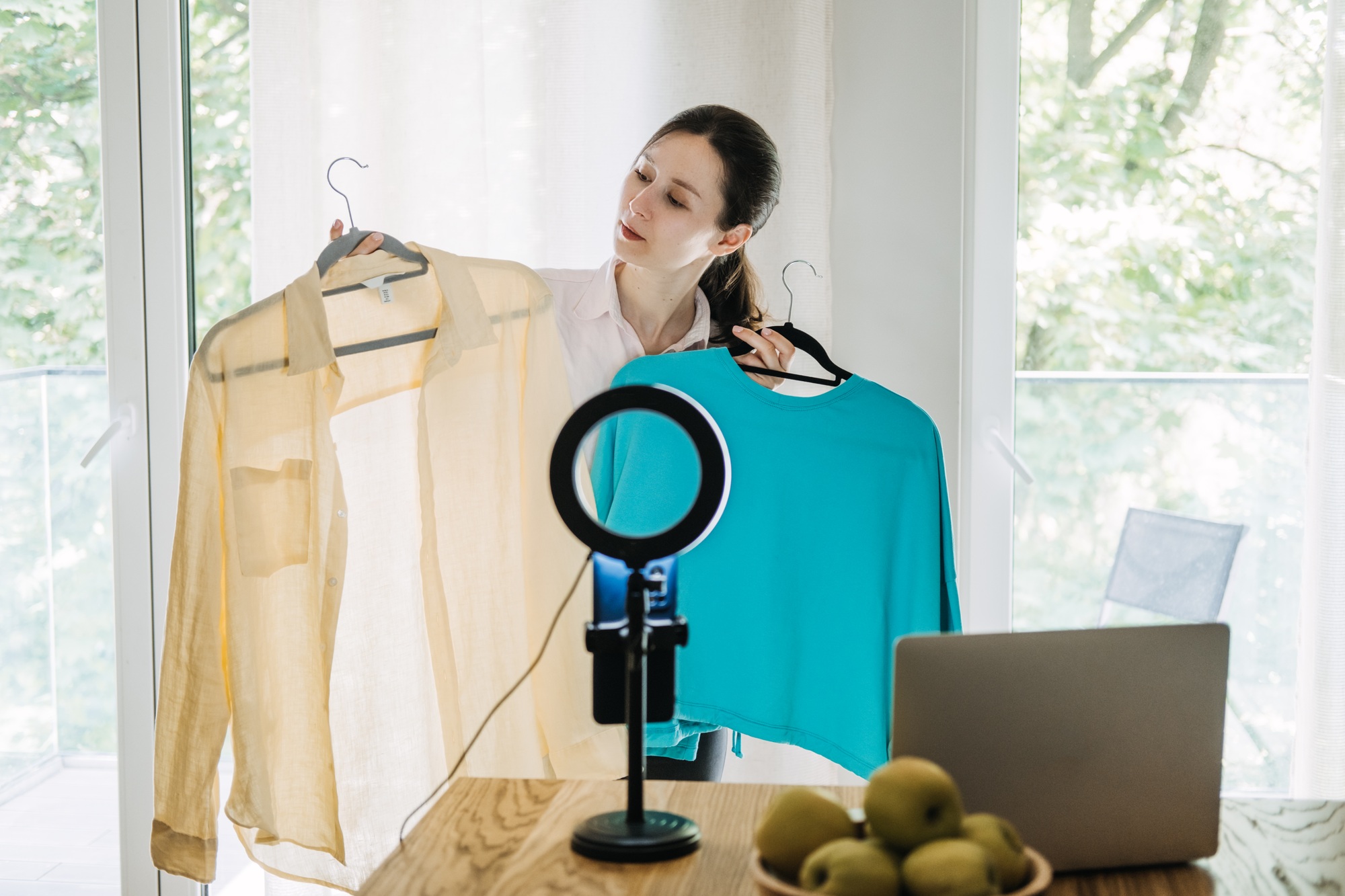 Fashion blogger showcasing outfits during live stream, content creation, influencer marketing