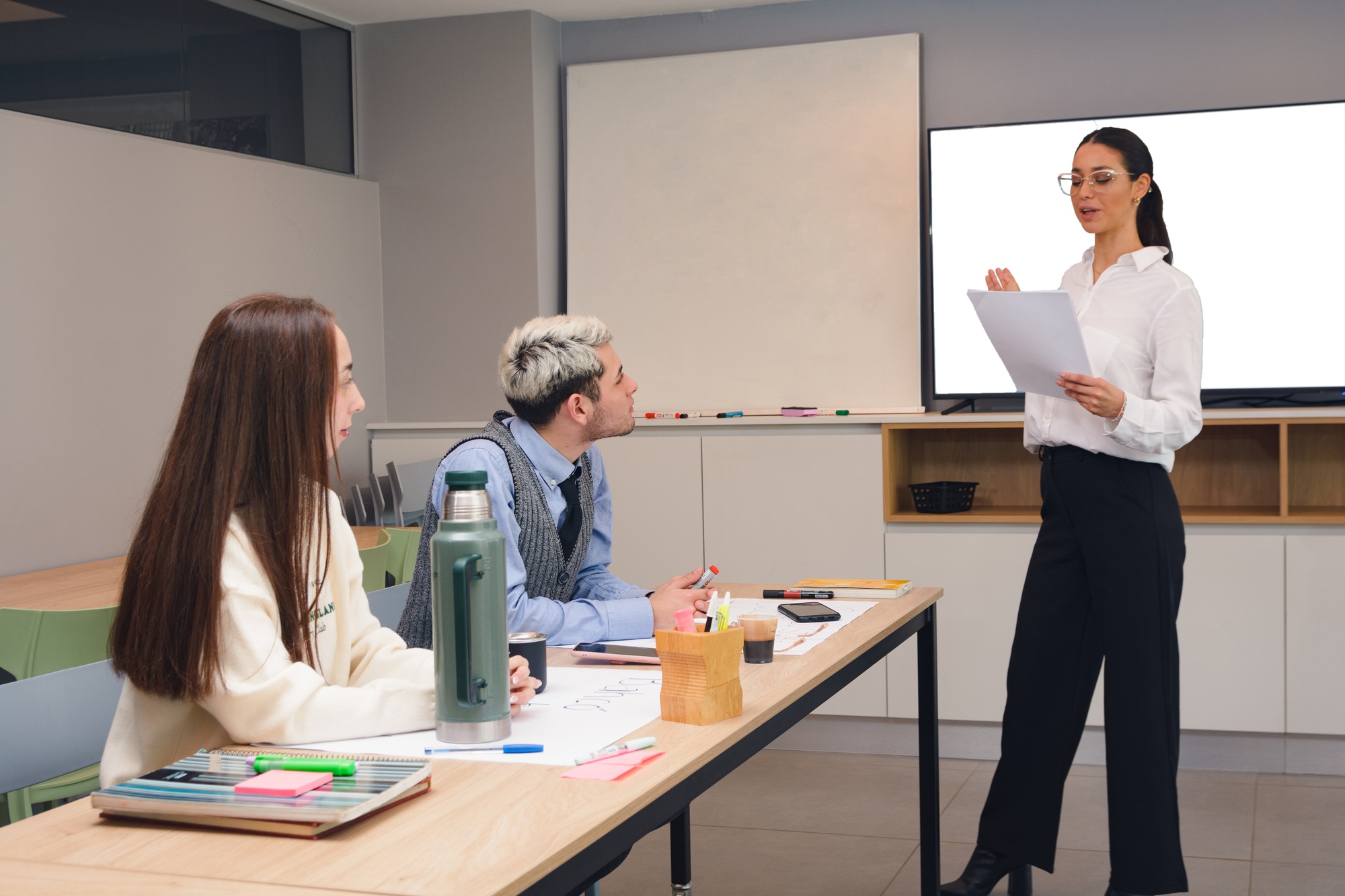woman reading and explaining company marketing strategy steps